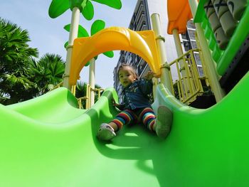 Low angle view of boy playing in playground