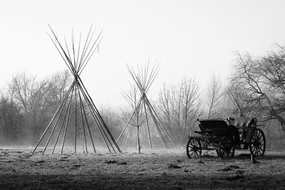 Horse cart on field against clear sky