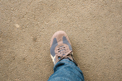 Low section of man standing on ground