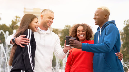 Friends standing on mobile phone