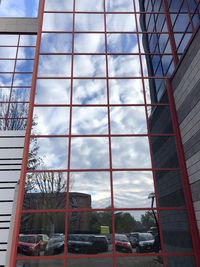 Low angle view of glass building against sky