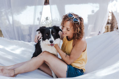 Young woman with dog sitting outdoors