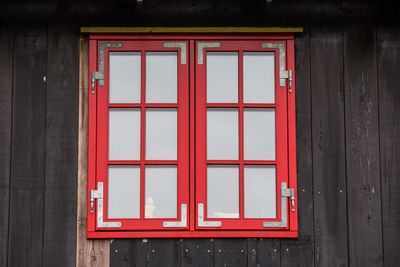 Red closed window of building