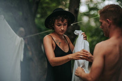 Young couple holding hands standing outdoors