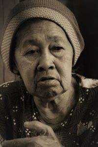 Close-up of thoughtful senior woman looking away at home