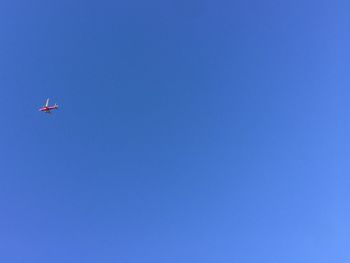 Low angle view of airplane flying in sky