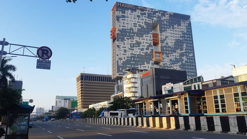 View of city street and buildings against sky