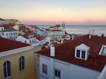 High angle view of townscape by sea against sky