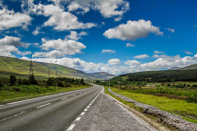 Road passing through landscape against sky