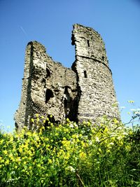 Low angle view of built structure against clear blue sky