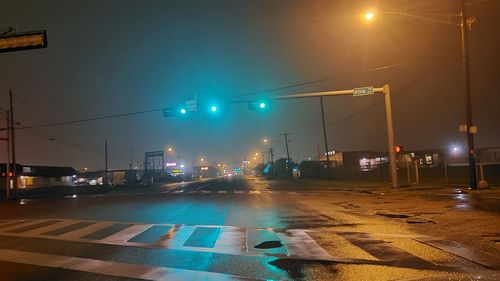 Illuminated street lights in city at night