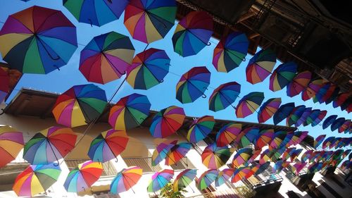 Low angle view of colorful umbrellas hanging outside temple
