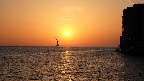 Scenic view of sea against orange sky during sunset