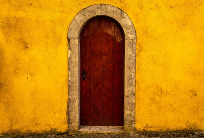 Closed door of yellow wall