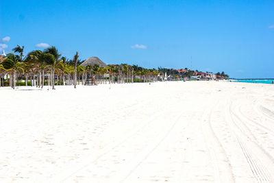 Panoramic view of people on beach against clear sky