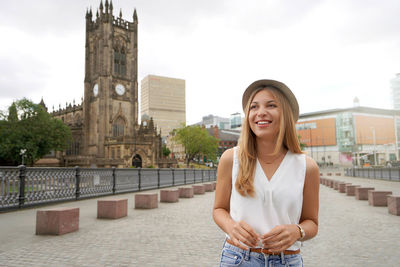 Portrait of pretty girl walking in the city of manchester, uk