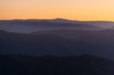 Scenic view of silhouette mountains against sky during sunset