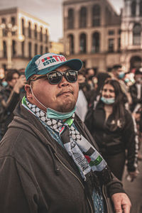 Portrait of man wearing sunglasses standing in city