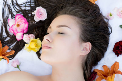 High angle view of young woman sleeping on bed in spa