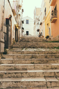 Low angle view of steps amidst buildings in town