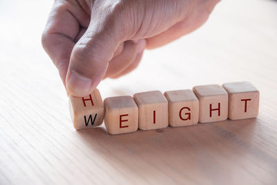 Midsection of person with text on table