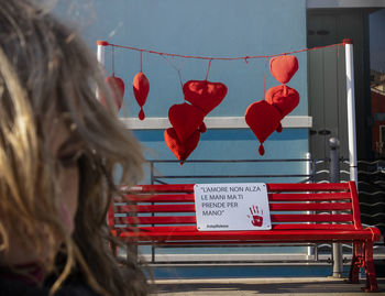 Rear view of woman walking with red umbrella