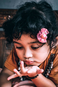 Close-up portrait of a girl holding flower