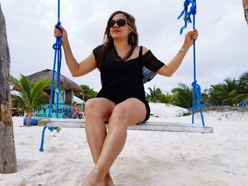 Portrait of young woman exercising at beach