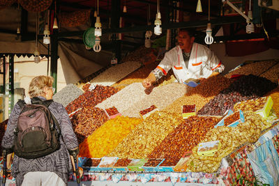 People for sale at market stall
