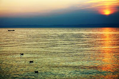 Scenic view of sea against sky at sunset