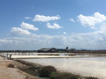 Scenic view of salt field against sky