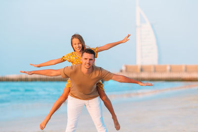 Full length of young couple on beach