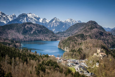 Scenic view of snowcapped mountains and lake against blue sky