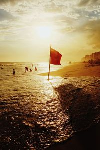 Scenic view of beach against sky during sunset