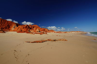 Scenic view of beach against blue sky