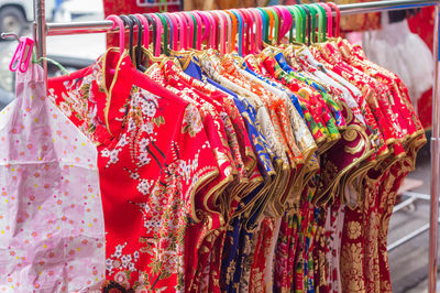 Close-up of clothes hanging in market for sale