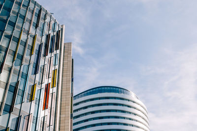 Low angle view of buildings against cloudy sky