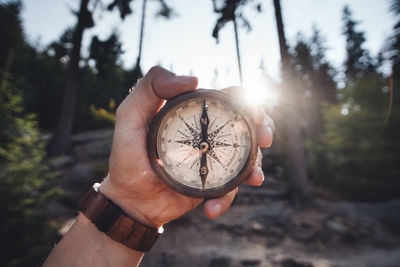 Close-up of hand holding navigational compass