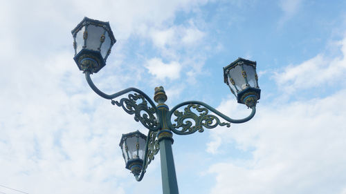 Low angle view of electric light on street against sky