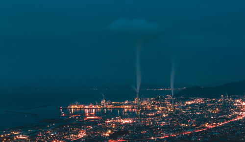 Illuminated cityscape against sky at night