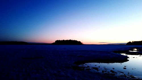 Scenic view of sea against clear sky at sunset