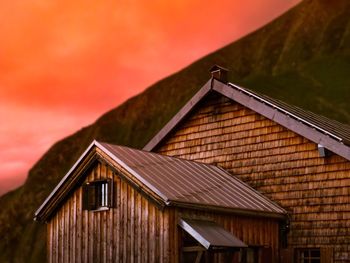 Low angle view of cottage against sky