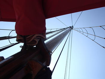 Low angle view of man against blue sky