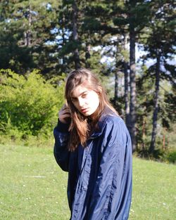 Portrait of beautiful young woman standing at park