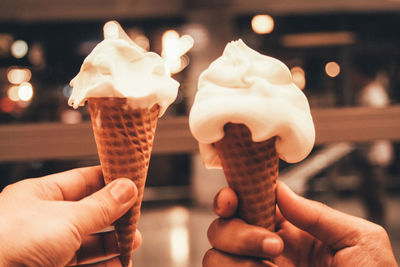 Close-up of hand holding ice cream cone