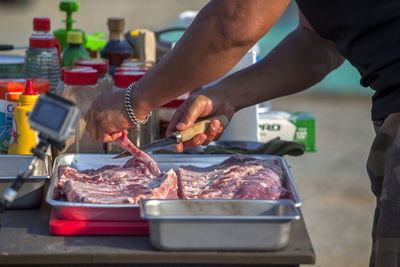 Chef cutting beef in kitchen counter