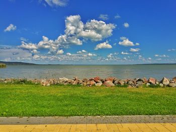 Scenic view of lake against cloudy sky