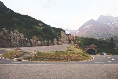 Road by mountain against sky