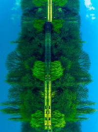 Scenic view of lake by trees against blue sky