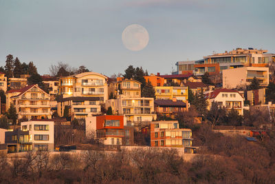 Buildings in city against clear sky